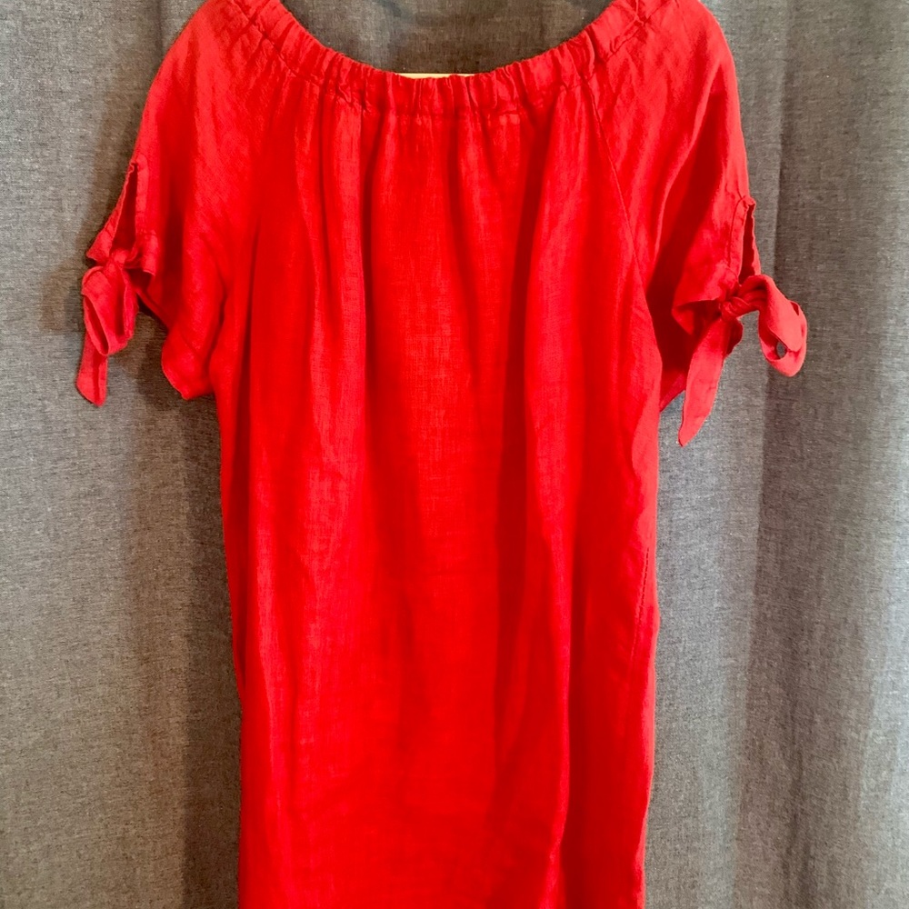 Coral off the shoulder linen dress with lace hem.